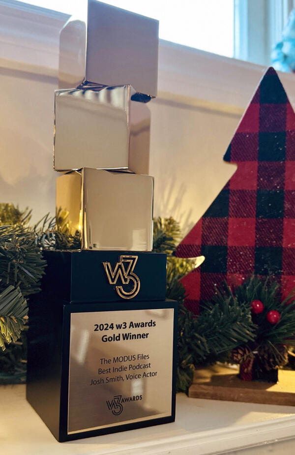 Josh Smith's W3 Podcast Gold Award for Excellence in Voice Acting Josh Smith's W3 Podcast Gold Award trophy recognizing excellence in voice acting for podcasts.